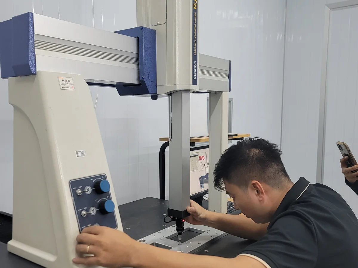 Quality engineer measuring a machined part at Far East High Tech