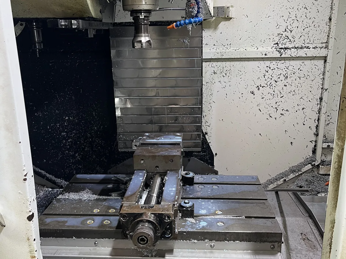 Milling cutter in cut on a fixtured workpiece inside a CNC machining center