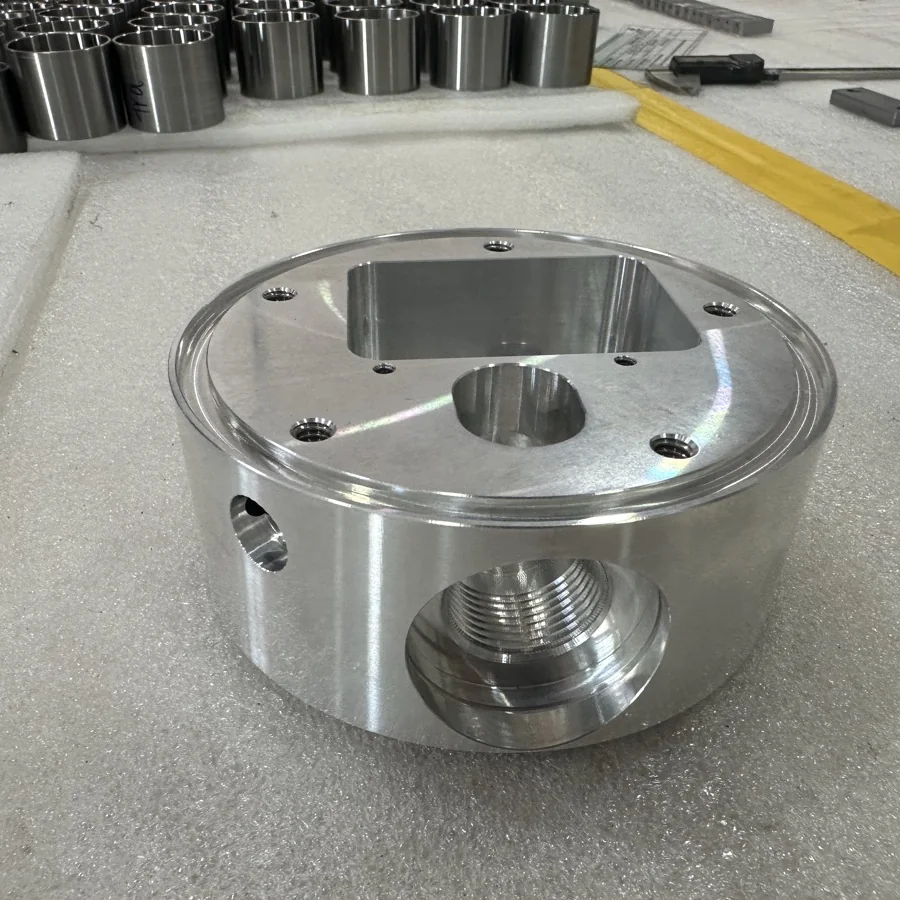 Machined aluminium valve housing with threaded port and counterbored mounting holes